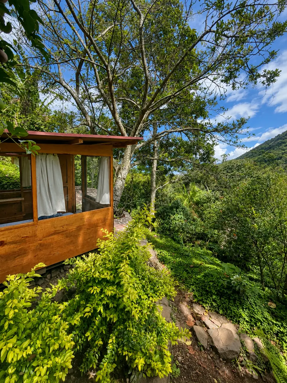 Tambo: exterior on the hillside, mountain view.