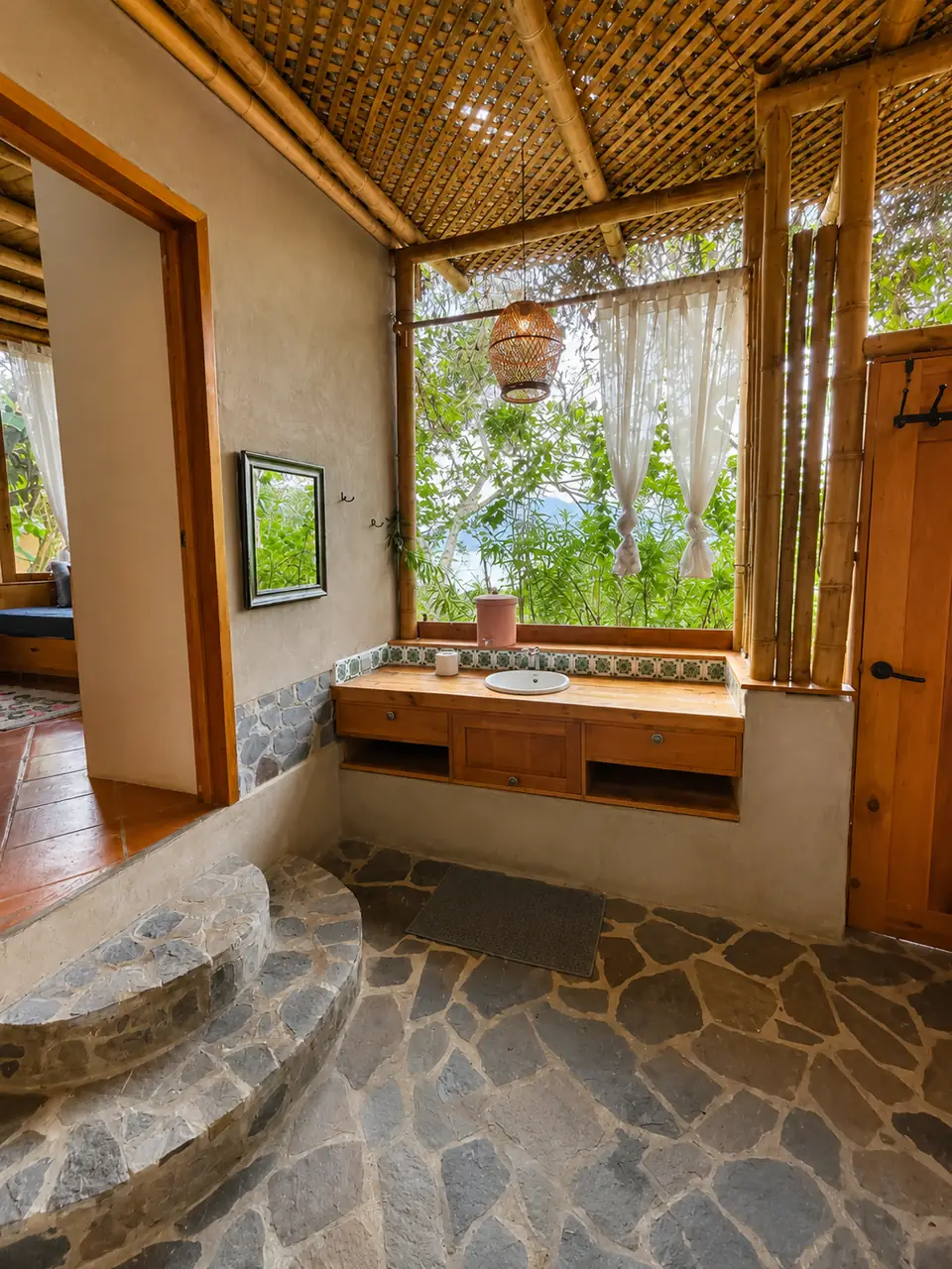Casita: bathroom sink and window, step up to the bedroom.
