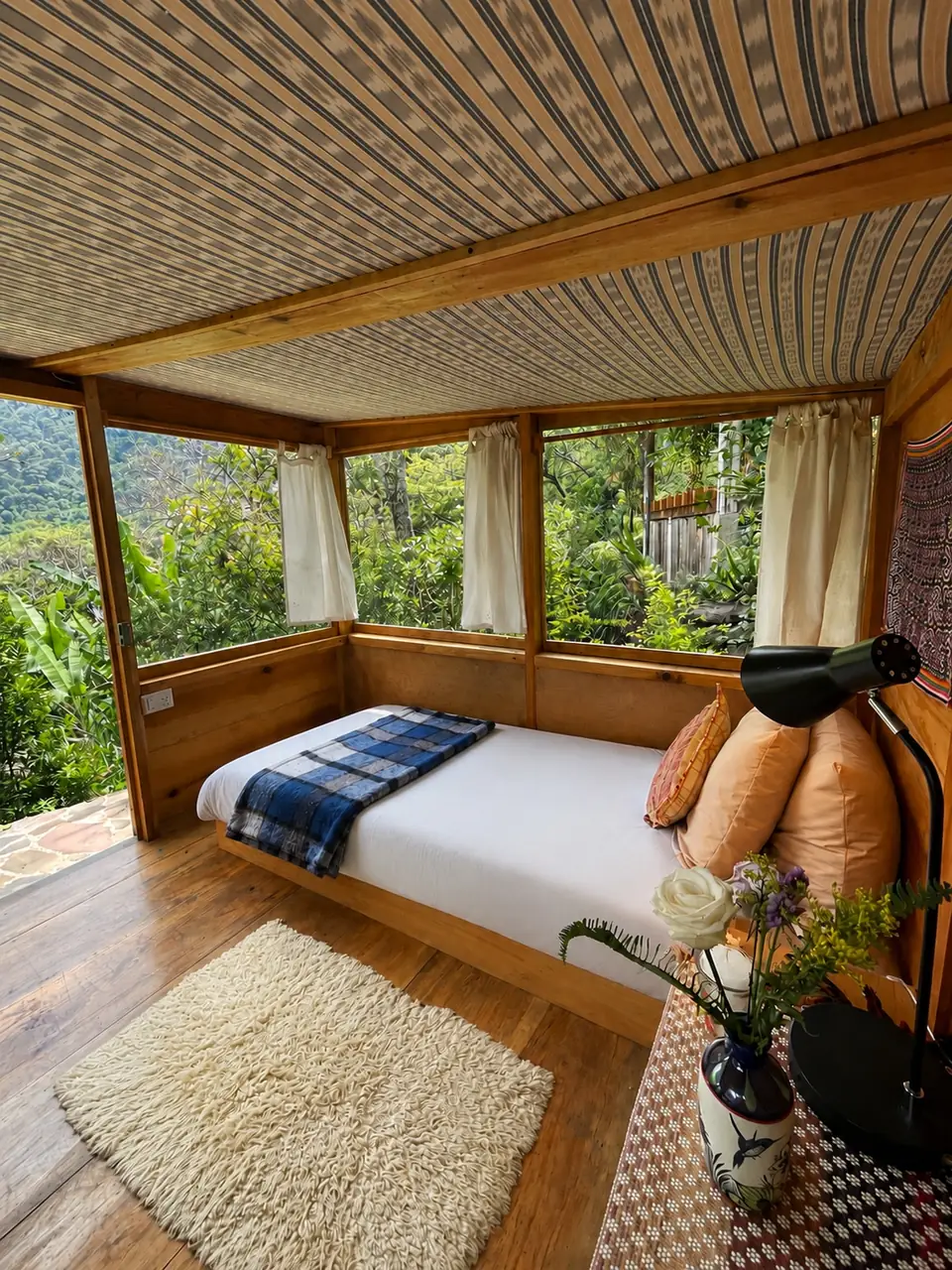 Tambo: single bed with valley view through screens.