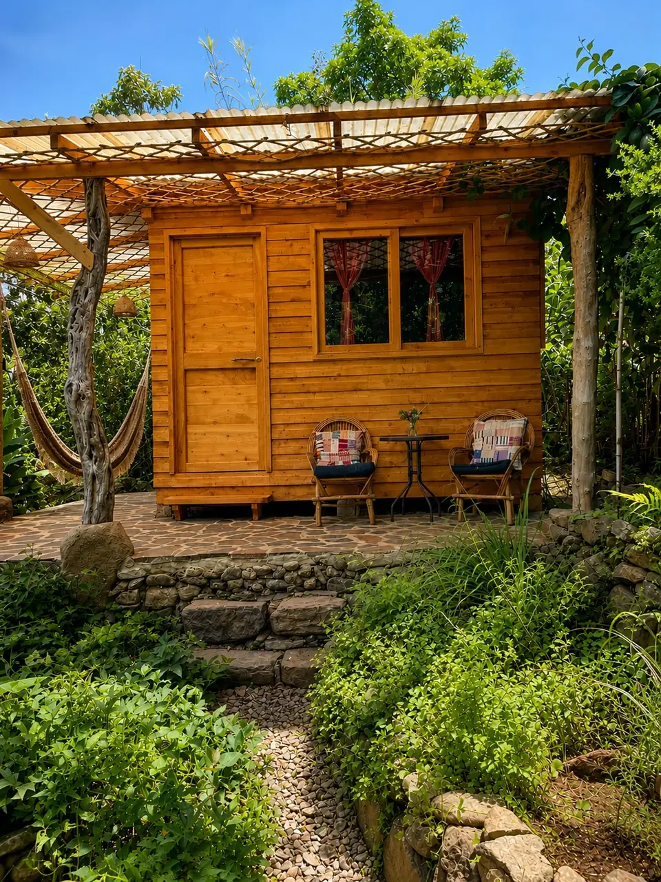 Garden Cabin: exterior with porch chairs and hammock.