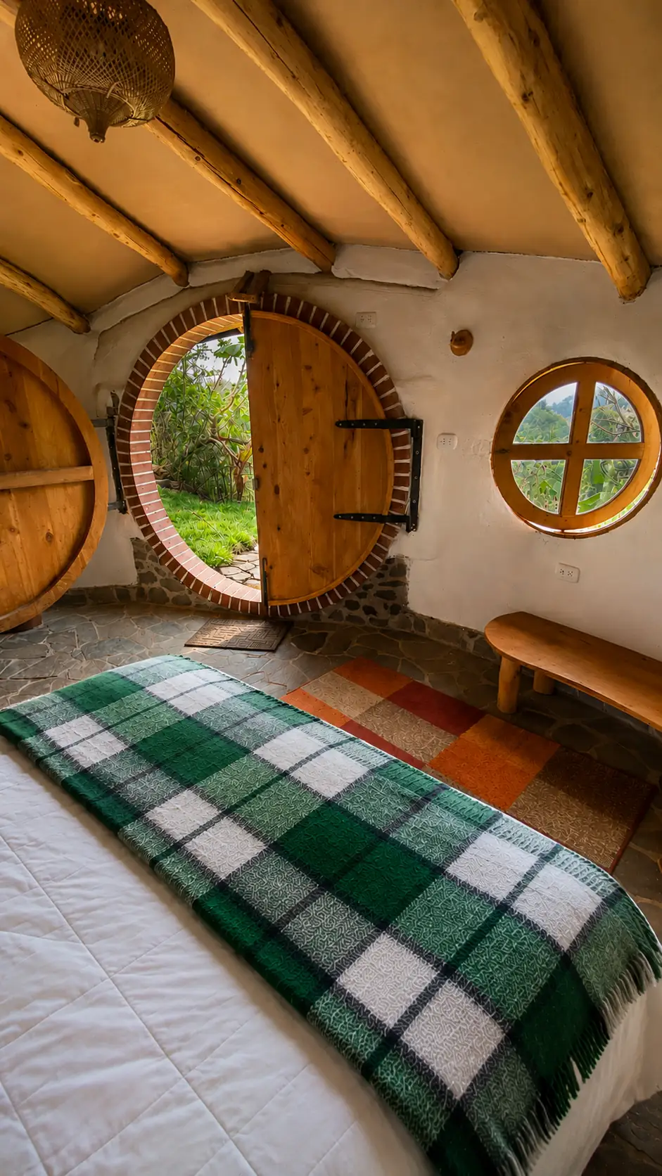 Hobbit House: round door seen from inside, bed in front.