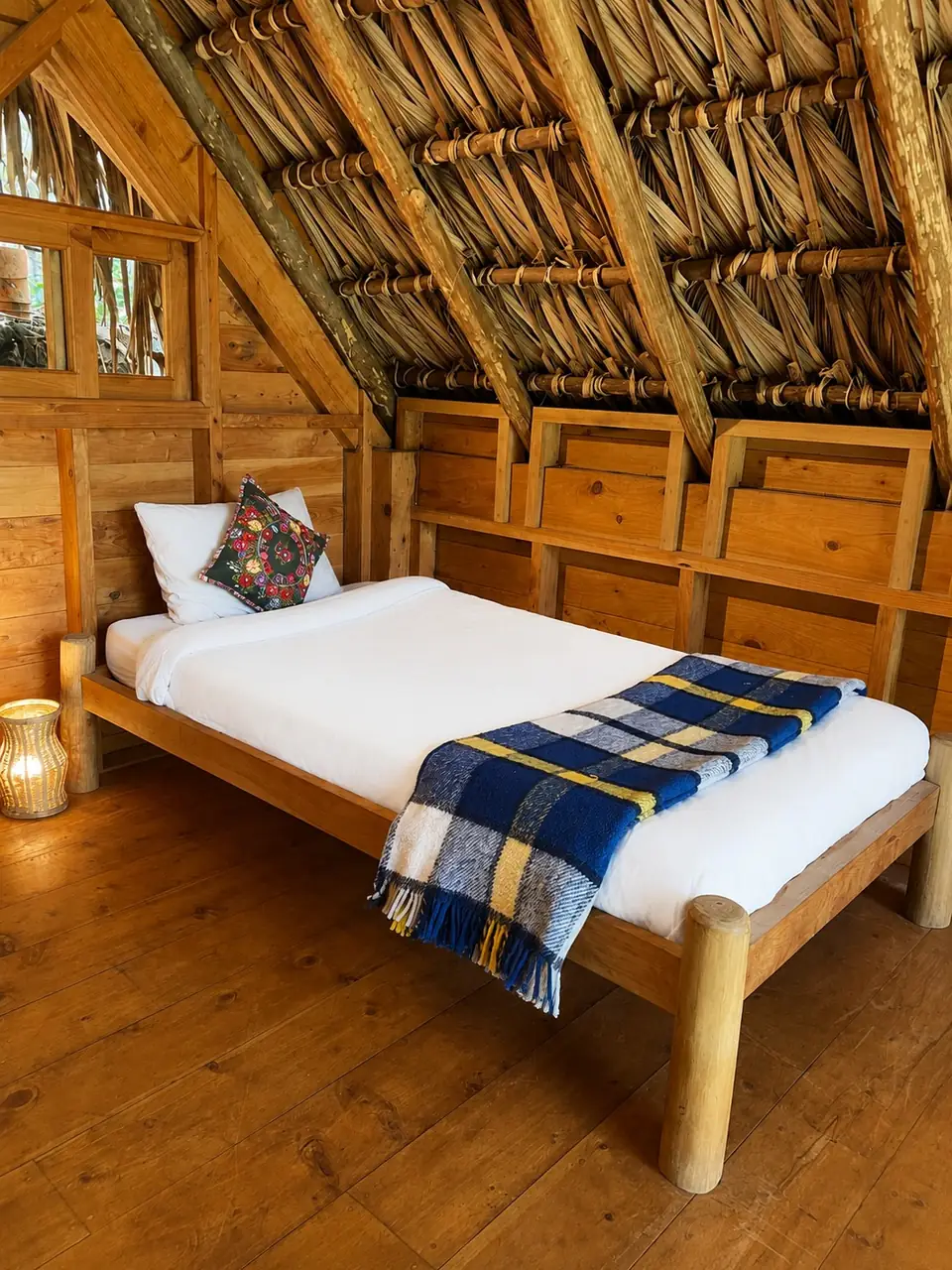 Kiya: loft: single bed under the thatched roof.