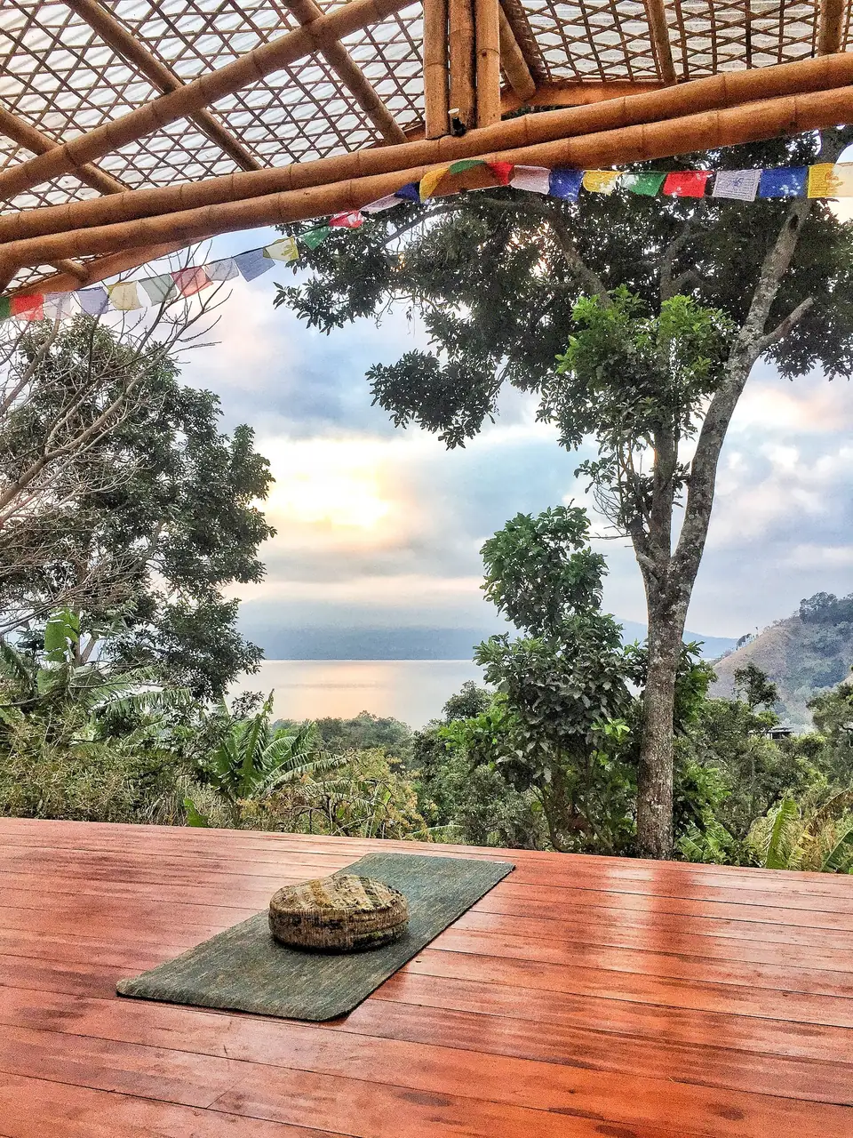 The open-air yoga platform with a view of the lake