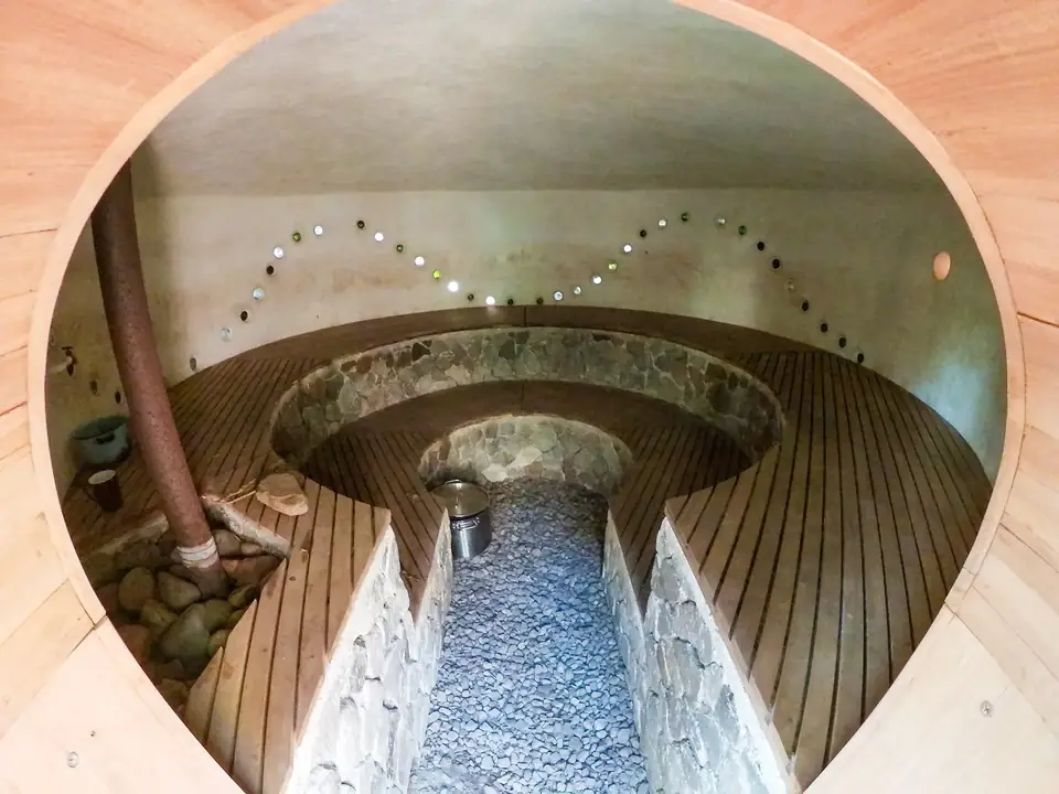 Inside the round, natural-build sauna