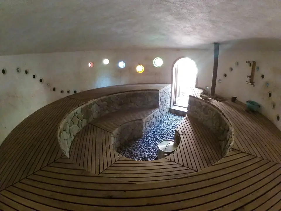 Inside the round, natural-build sauna