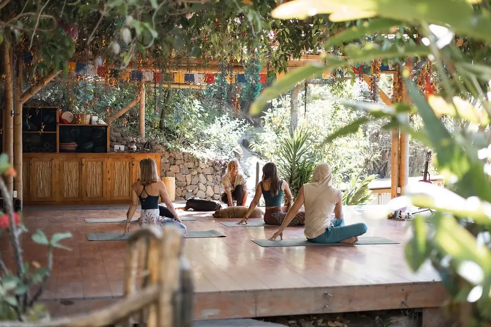 A group practicing yoga in the shala at Casa Kula